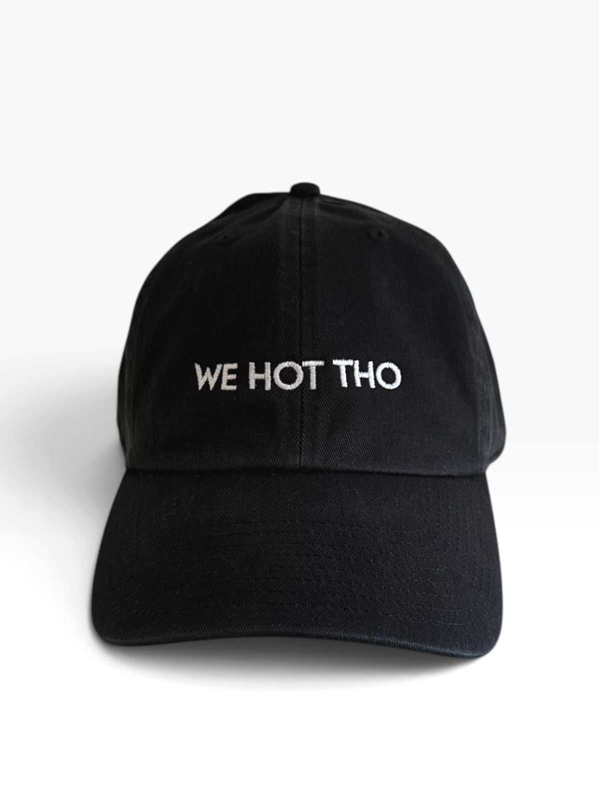 A black baseball cap with 'WE HOT THO' embroidered in white across the front, Sydney Los Angeles logo on the back.