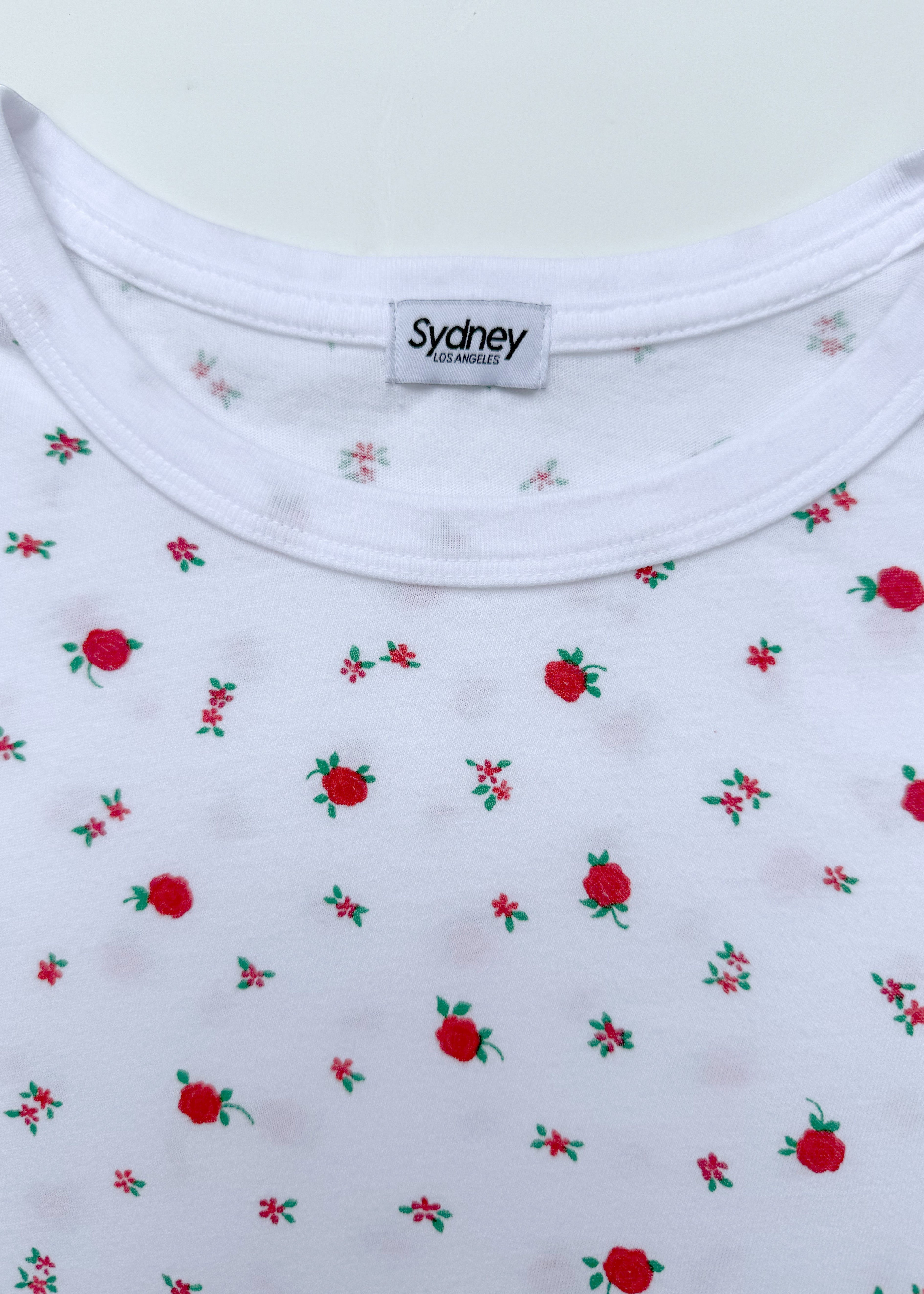 Sydney Los Angeles white 100% cotton t-shirt with a ditsy floral print of red roses and green leaves.